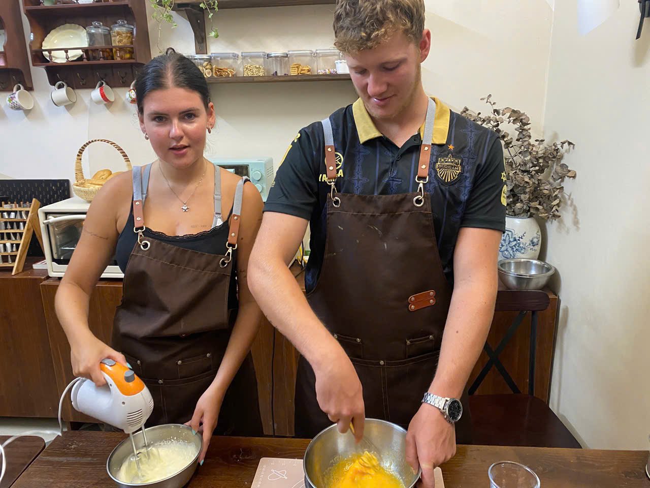 Guests mixing cake batter together with a hand mixer