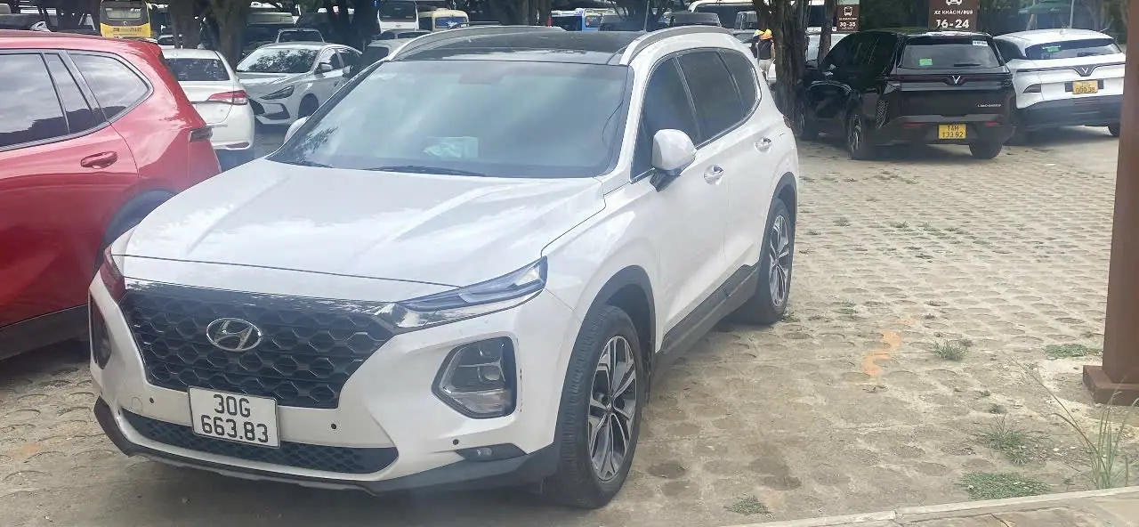 A white Hyundai Santa Fe seven-seater, side view
