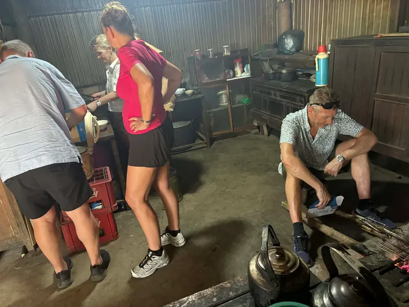 Guests helping prepare food in the farmhouse kitchen