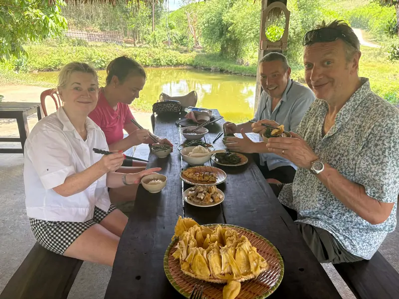 Guests enjoying a farm-cooked lunch by the pond