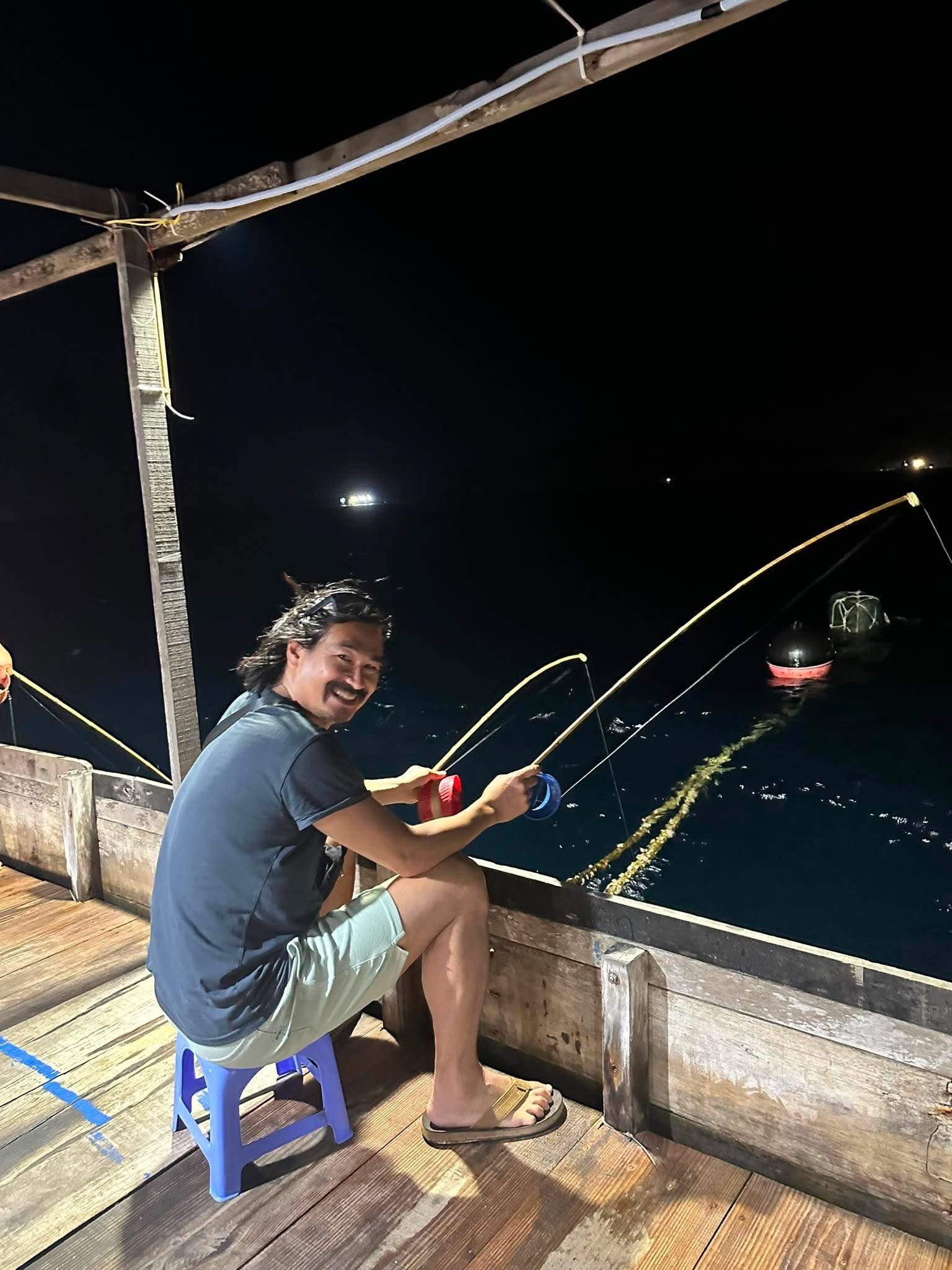 Fishing lamps glowing over the water at night