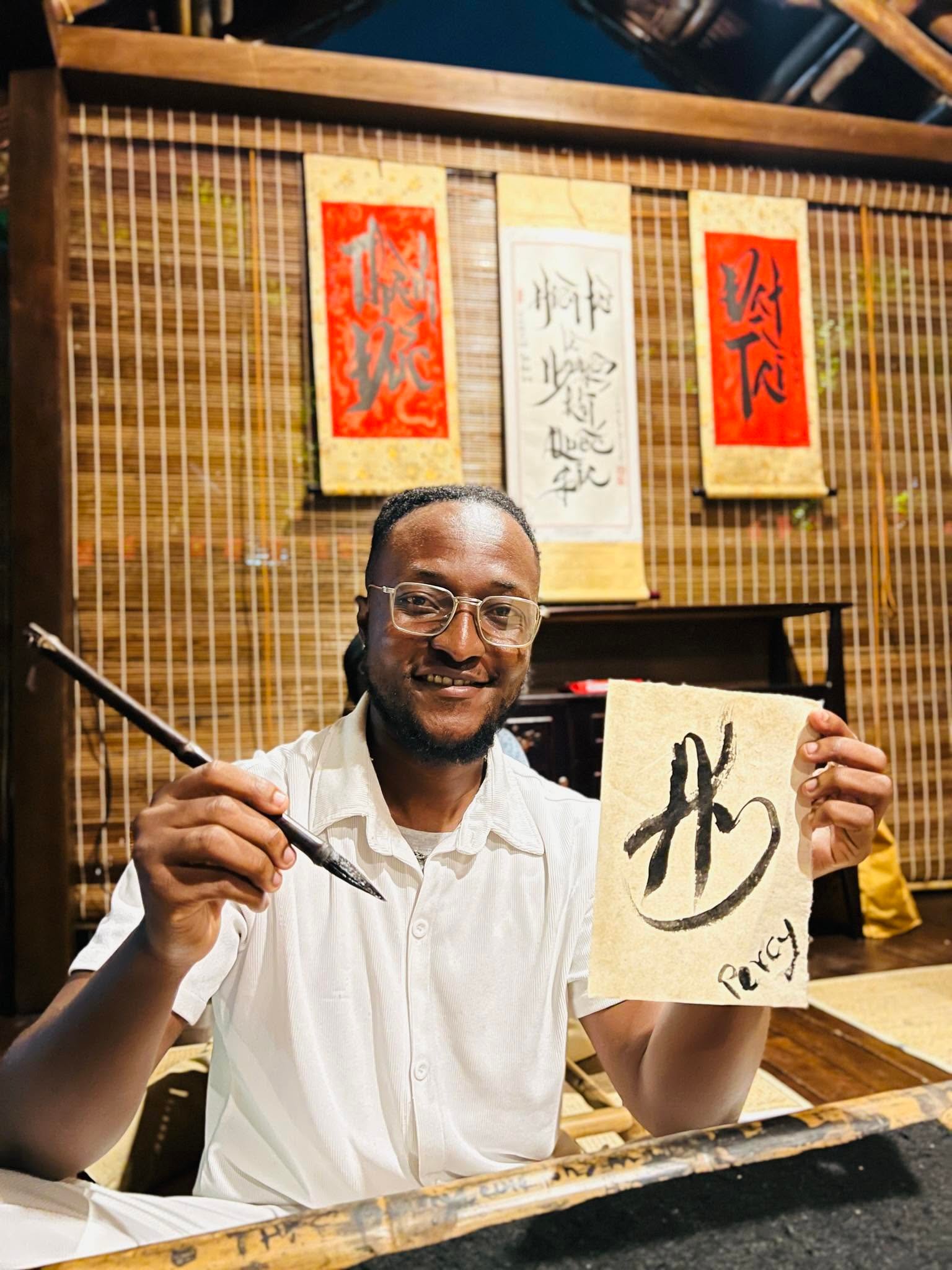 Guest holding their finished calligraphy artwork