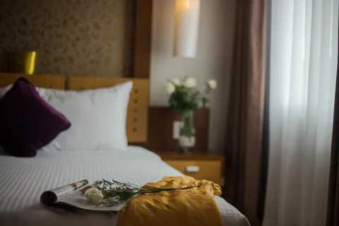 Family Suite: a magazine and a rose left on the turned-down bed