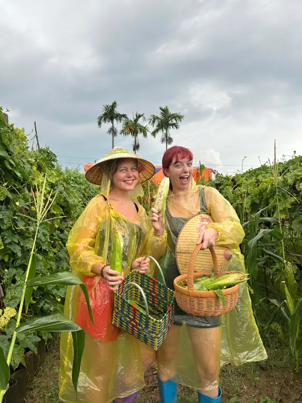 Guests in conical hats holding baskets of freshly picked corn