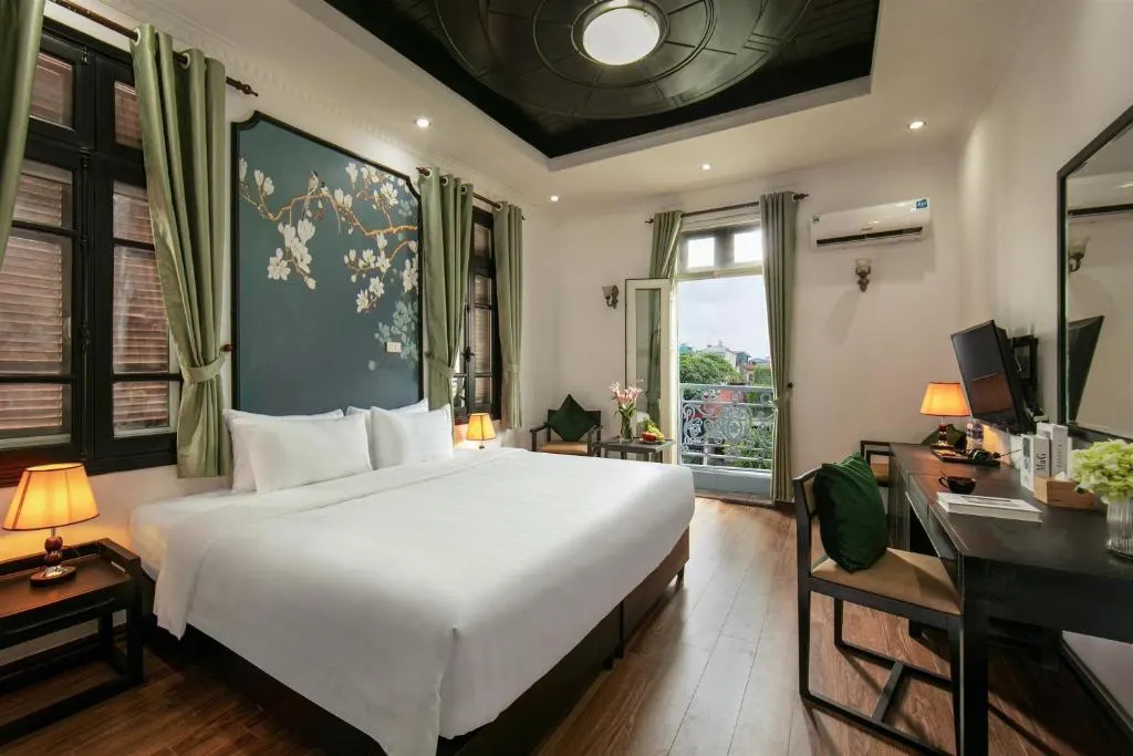 Room at Old Quarter Charm with a king bed and painted floral headboard