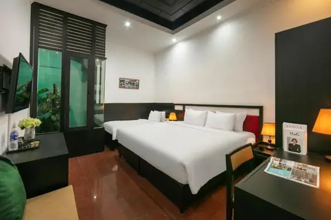 Standard Triple: the two beds seen from the desk, with the television opposite